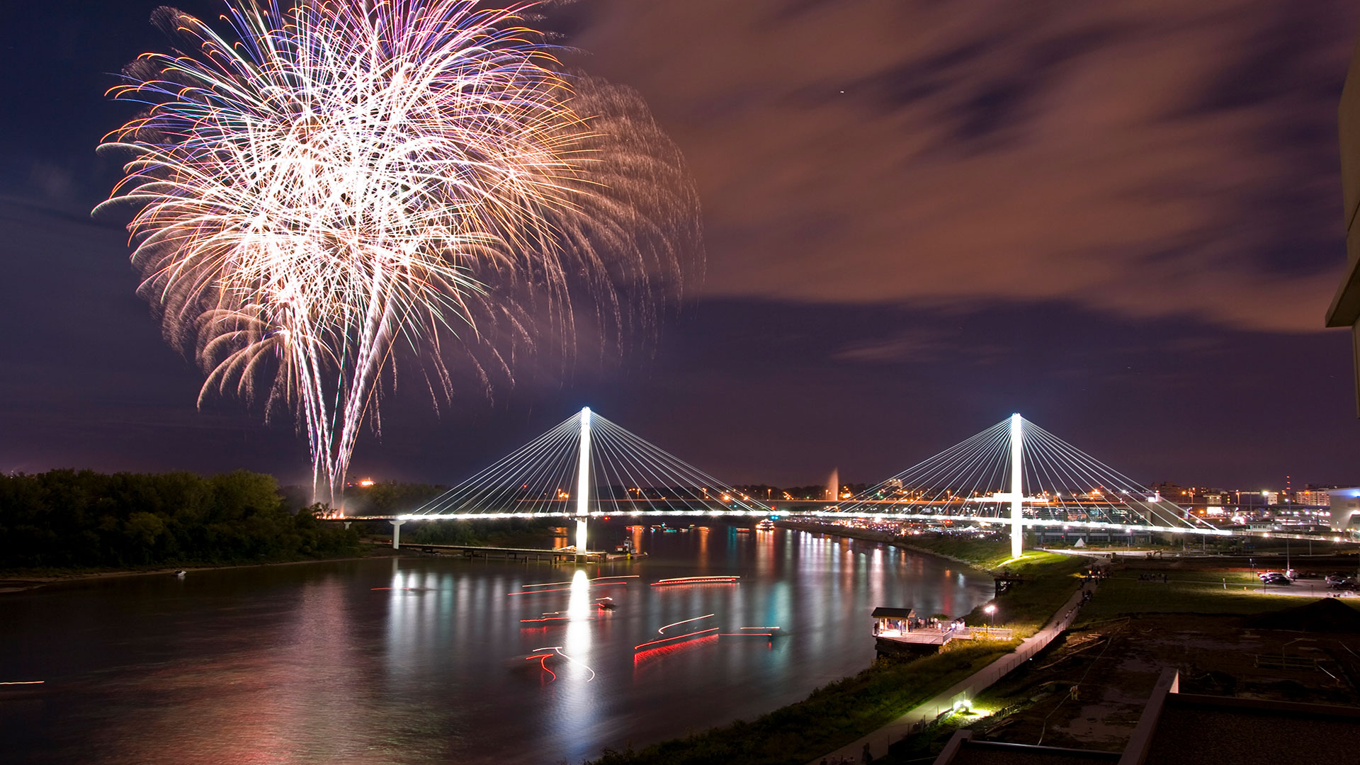 Fuegos artificiales iluminando el Puente Peatonal Bob Kerrey sobre el río Misuri en Omaha, Nebraska.