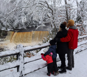 Family at Tahquamenon Falls during winter near Sault Ste. Marie, Michigan